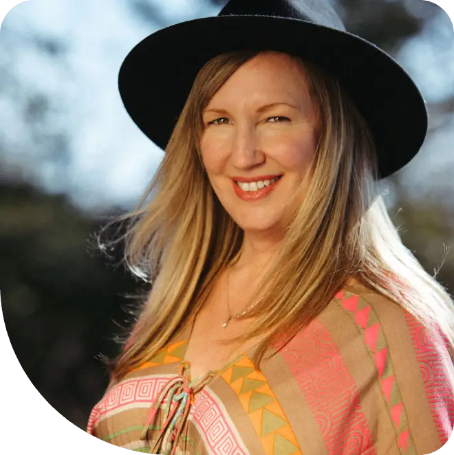 A woman wearing a hat and a colorful outfit.